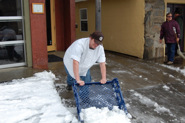 Firewood employee, Mike Taylor improvises to clear snow in front of the restaurant as Michael Ninos, owner of The Victoria Inn and V's offers a more traditional method.~by Kelly Ellefritz